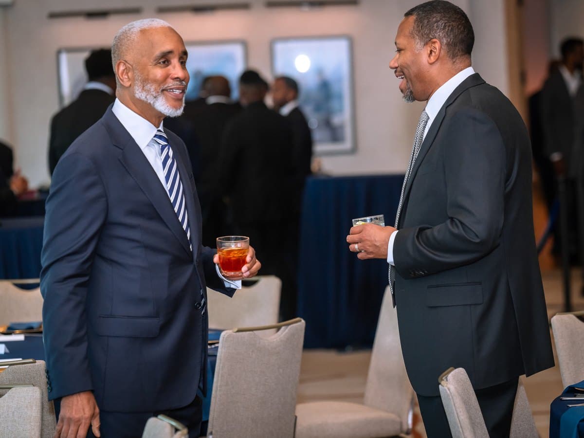 Two members in conversation at the Global Dinner, Dallas