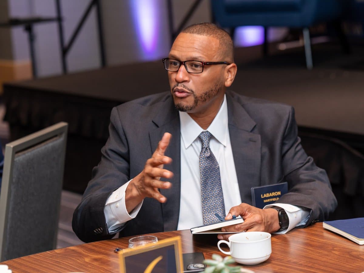 Labaron Hartfield speaking at a BEM forum table