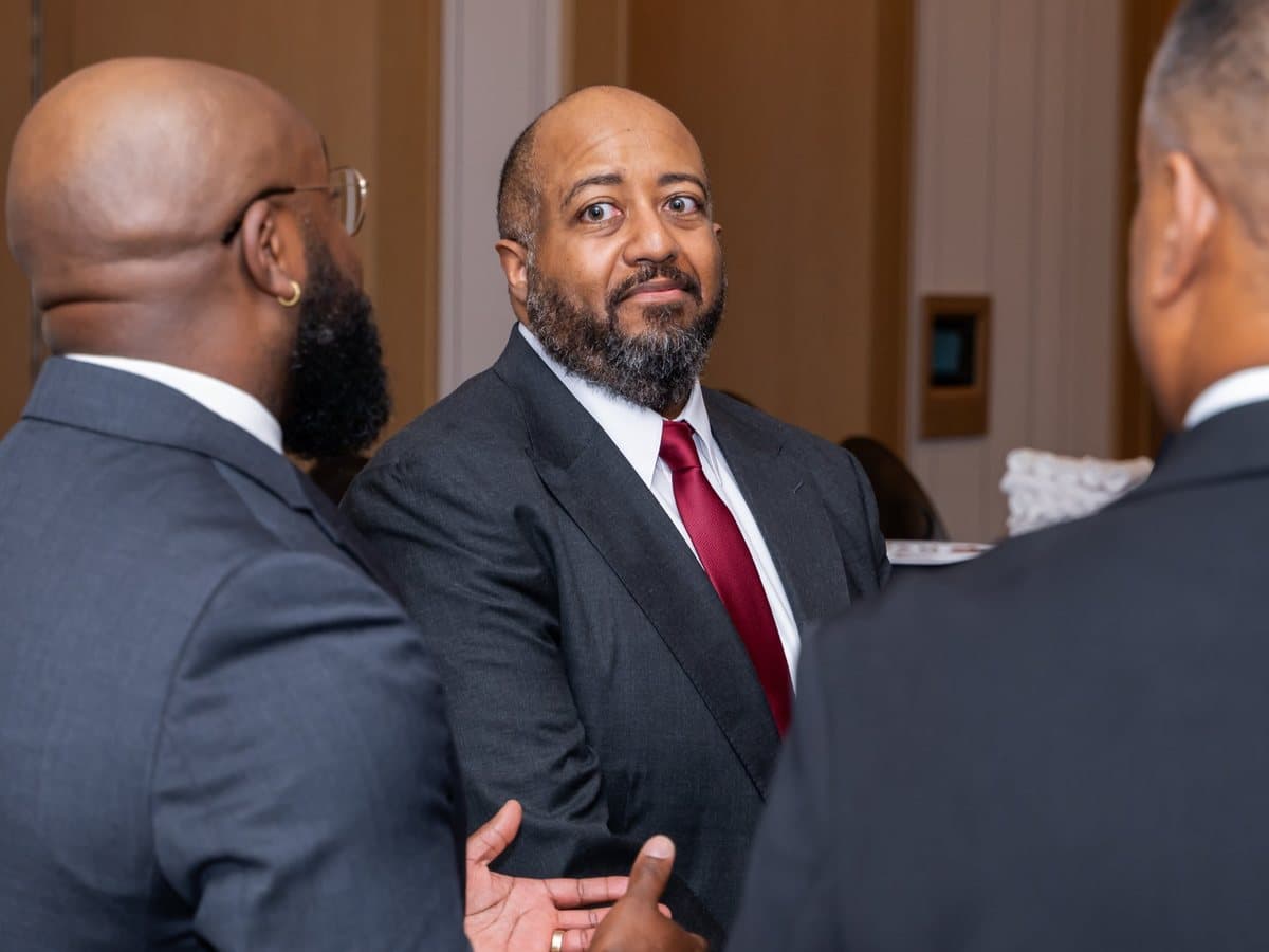 Three members in conversation at a BEM reception